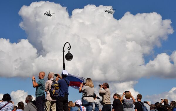 Жители на набережной Санкт-Петербурга наблюдают пролет корабельных транспортно-боевых вертолетов Ка-29 во время Главного военно-морского парада России - Sputnik Армения