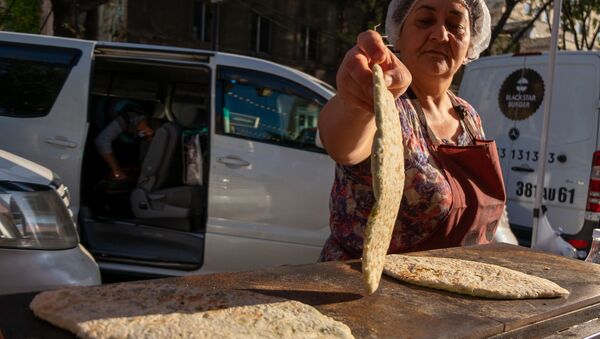 Женщины, прибывшие из Степанакерта, готовят и продают “женгялов хац” в центре Еревана (19октября 2020). Еревaн - Sputnik Արմենիա