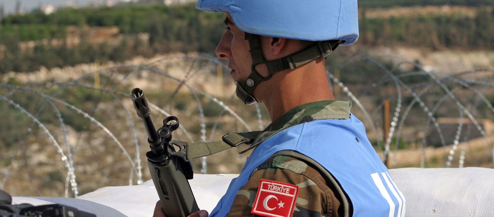Турецкий член миротворческих сил ООН в Ливане стоит у входа в турецкую инженерную строительную компанию, расположенную недалеко от южного портового города Тир (16 ноября 2006). Ливан - Sputnik Արմենիա, 1920, 26.08.2021