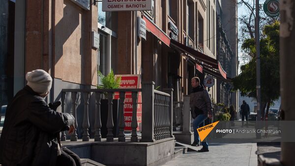 Люди проходят мимо вывески пункта обмена валюты в Ереване - Sputnik Արմենիա