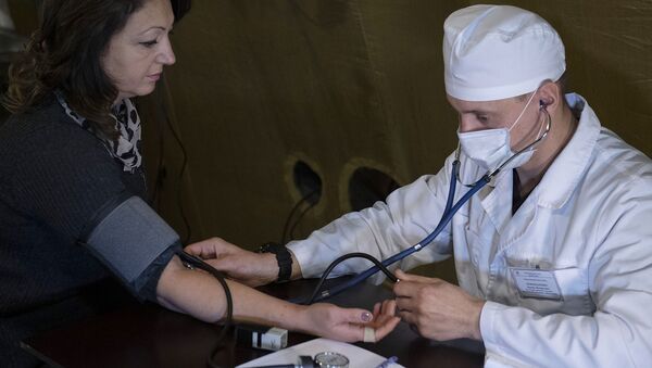 Врач проводит прием пациента на базе госпиталя развернутого Минобороны России на территории аэропорта в Степанакерте (1 декабря 2020). Карабах - Sputnik Армения