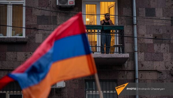 Житель столицы наблюдает за шествием оппозиции с требованием отставки премьер-министра (5 декабря 2020). Еревaн - Sputnik Армения