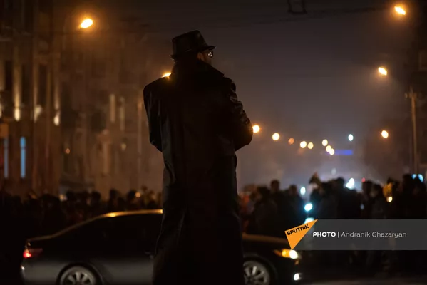 Мужчина в плаще следит за шествием оппозиции, требующих отставки правительства Армении (14 декабря 2020). Еревaн Мужчина в плаще следит за шествием оппозиции, требующих отставки правительства Армении (14 декабря 2020). Еревaн - Sputnik Армения