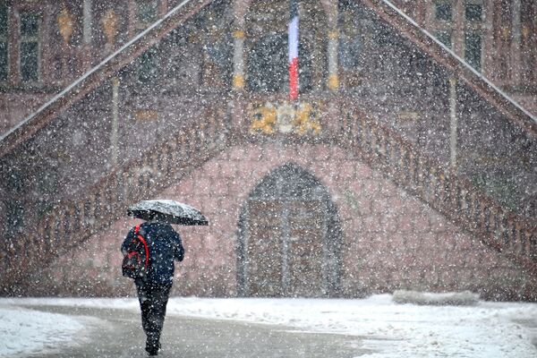 Женщина ходит под снегом по улице города Мюлуз в восточной Франции - Sputnik Армения