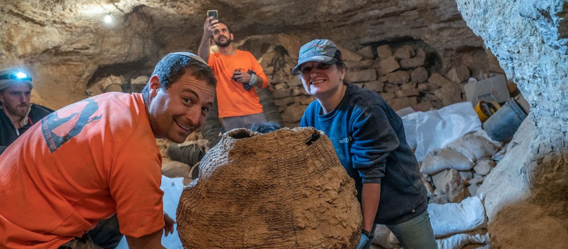 Израильские археологи с древней корзиной, найденной в пещере Мурабаат в Иудейской пустыне недалеко от Мертвого моря - Sputnik Армения, 1920, 17.03.2021