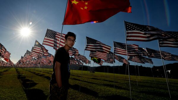 Китайский студент по обмену Джейсон Чай рядом с китайским флагом, находящийся среди флагов США, установленных в память жертвам терактов 11 сентября 2001 (9 сентября 2014). Малибу - Sputnik Արմենիա
