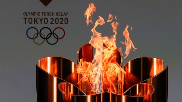 Олимпийский огонь во время эстафеты Олимпийского огня в Токио-2020 в префектуре Фукусима, Япония - Sputnik Արմենիա