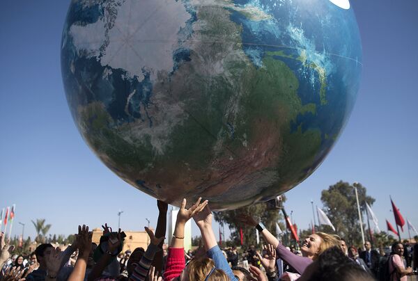 Члены всемирной конференции ООН по вопросам изменения климата с макетом Земли - Sputnik Армения