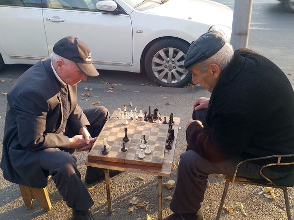 Пожилые люди играют в шахматы на одной из улиц Еревана - Sputnik Армения
