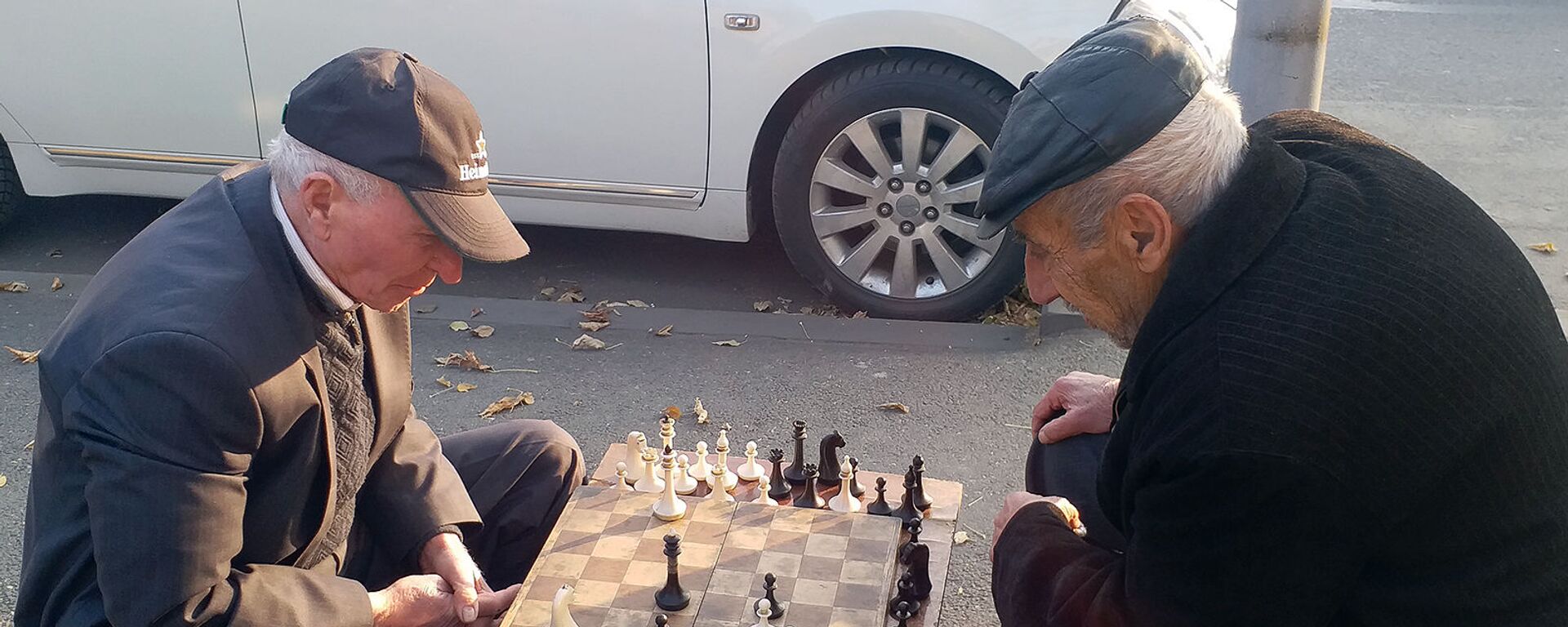 Пожилые люди играют в шахматы на одной из улиц Еревана - Sputnik Армения, 1920, 31.12.2023
