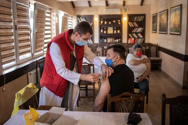 Мужчина получает дозу китайской вакцины Sinopharm против коронавирусной болезни (COVID-19) в ресторане в Крагуеваце, Сербия - Sputnik Армения