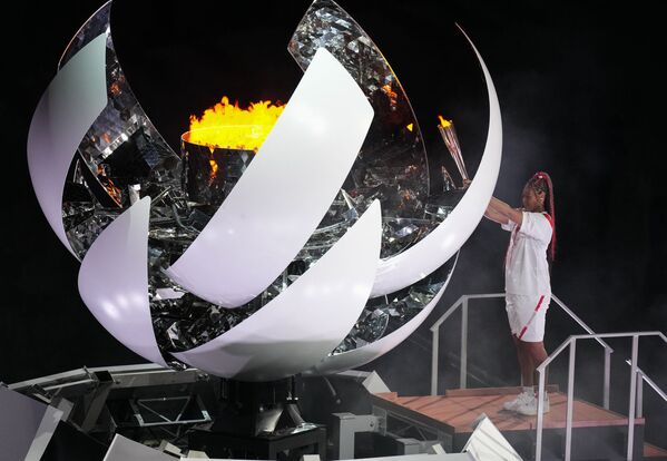Теннисистка Наоми Осака зажигает олимпийский огонь на церемонии открытия XXXII летних Олимпийских игр (23 июля 2021). Токио - Sputnik Армения