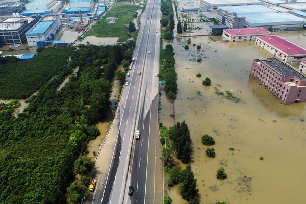 Затопленные промышленные здания у шоссе после проливного дождя в Синьсяне, провинция Хэнань, Китай - Sputnik Армения
