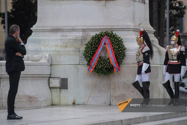Сотрудник протокольной службы президента Италии рассматривает венок, возложенный от имени армянской делегации на площади Венеции. - Sputnik Армения