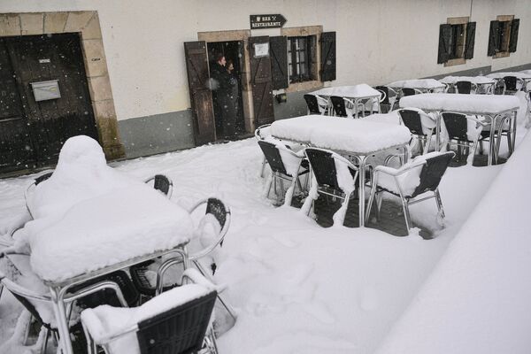 Снег покрывает стулья и столы бара-ресторана в Ронсесвальесе, северная Испания. Власти объявили о снегопаде и экстремально низких температурах в ближайшие несколько дней на севере страны - Sputnik Армения