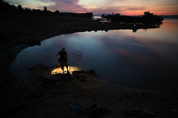 Рыбак на берегу крупнейшего в Китае пресноводного озера Поян в Цзюцзяне, центральной китайской провинции Цзянси. - Sputnik Армения
