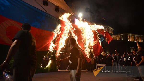 Участники факельного шествия традиционно сжигают флаги Азербайджана и Турции (23 апреля 2023). Еревaн - Sputnik Армения