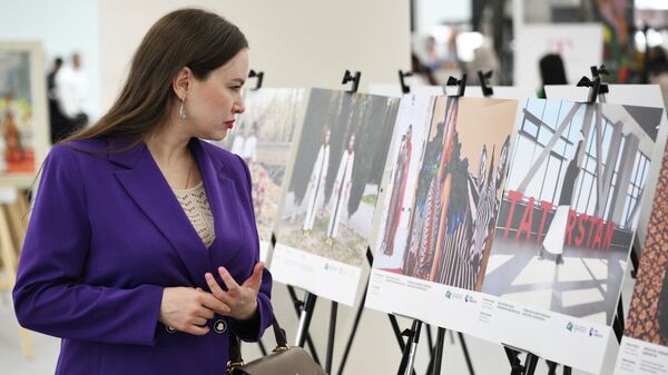Посетитель выставки Международного конкурса фотожурналистики имени Андрея Стенина - Sputnik Армения