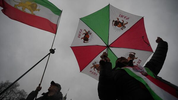 Протестующие с флагами Шаханшахского Государства Иран во время демонстрации перед зданием парламента в Лондоне (13 января 2026). Великобритания - Sputnik Армения