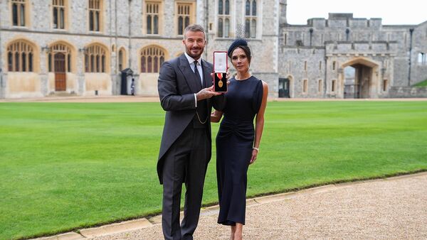 Сэр Дэвид Бекхэм с супругой Викторией после присвоения рыцарского звания в Виндзорском замке (4 ноября 2025). Англия - Sputnik Армения