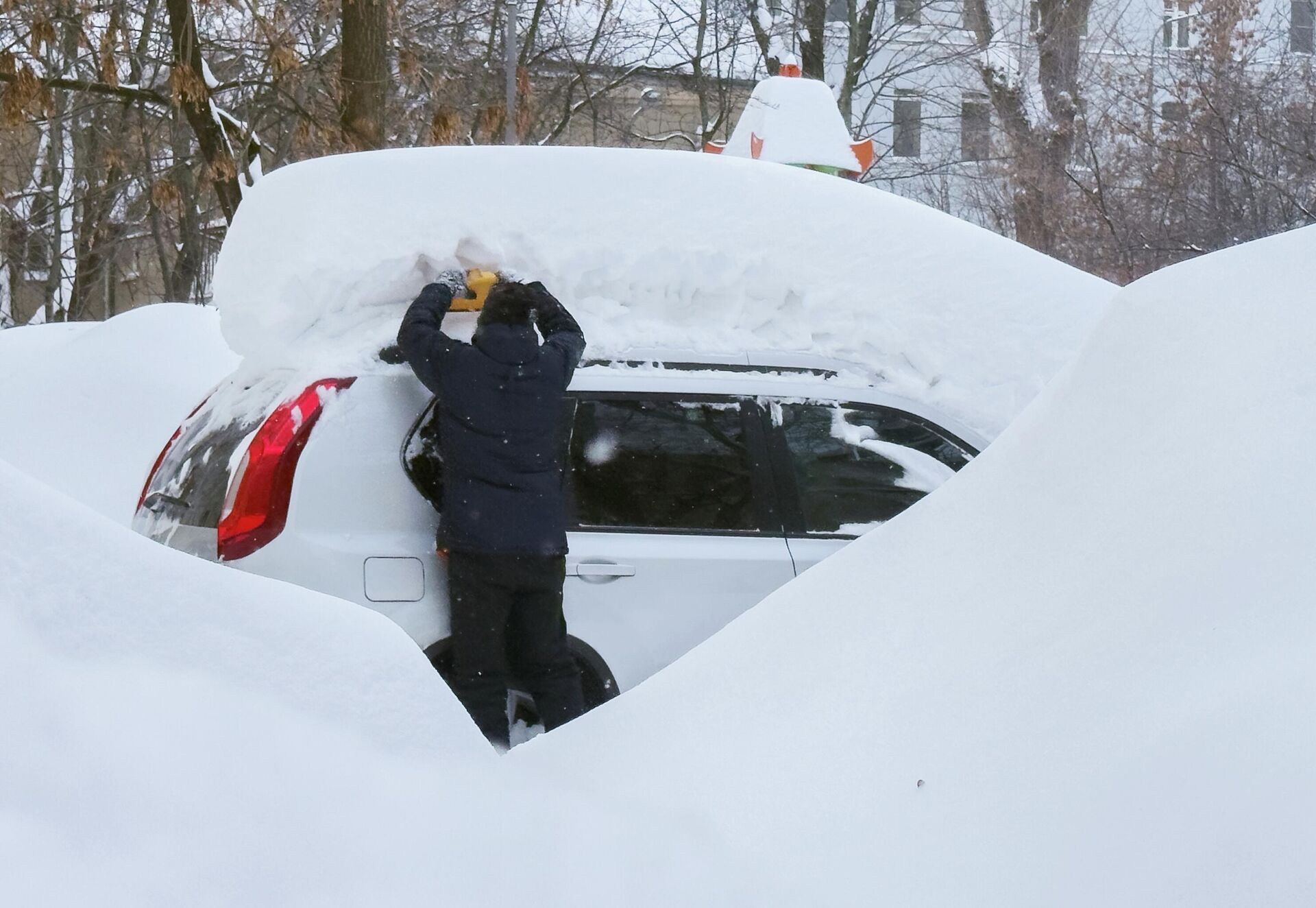 Мужчина чистит автомобиль после снегопада в Москве - Sputnik Армения, 1920, 21.02.2026