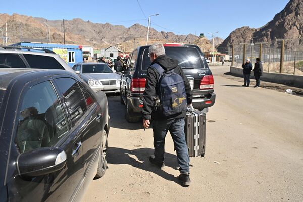 Люди готовятся к дальнейшей дороге после пересечения границы - Sputnik Армения