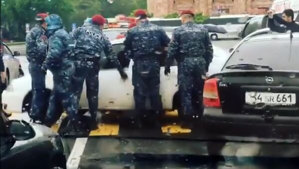 Сотрудники полиции пытаются открыть автомобили, перекрывшие улицы - Sputnik Армения