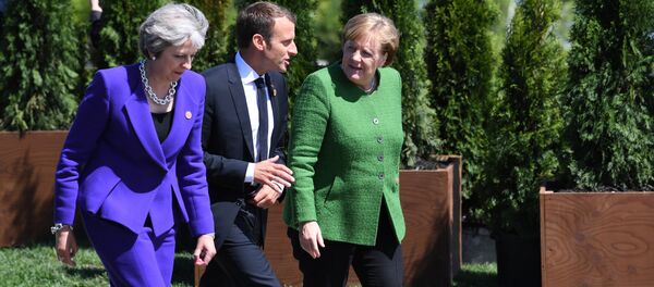 Премьер-министр Великобритании Тереза Мэй, президент Франции Эммануэль Макрон и канцлер Германии Ангела Меркель во время саммита G7 (8 июня 2018). Ла Мальбе, Квебек, Канада - Sputnik Армения