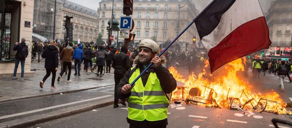 Участник акции протеста движения автомобилистов желтые жилеты с французским триколором в районе Триумфальной арки (8 декабря 2018). Париж Участник акции протеста движения автомобилистов желтые жилеты с французским триколором в районе Триумфальной арки (8 декабря 2018). Париж - Sputnik Армения