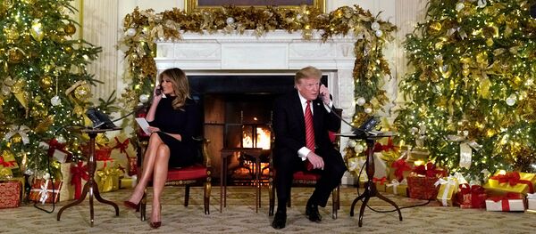 Президент США Дональд Трамп и первая леди Мелания Трамп участвуют в телефонных звонках NORAD Santa tracker из Белого дома (24 декабря 2018). Вашингтон - Sputnik Армения