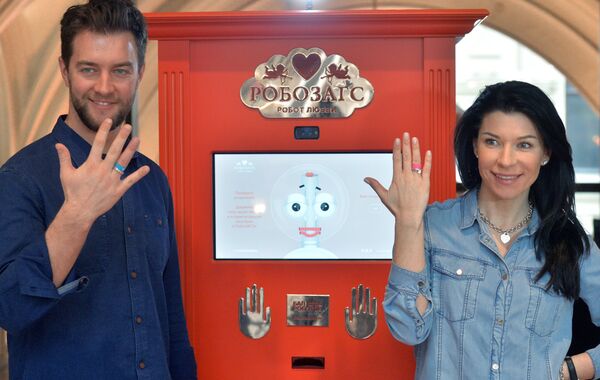 Актриса Екатерина Волкова с супругом Андреем Карповым демонстрируют кольца, выданные Робозагсом в ГУМе во время заключения виртуального брака. Актриса Екатерина Волкова с супругом Андреем Карповым демонстрируют кольца, выданные Робозагсом в ГУМе во время заключения виртуального брака. - Sputnik Армения