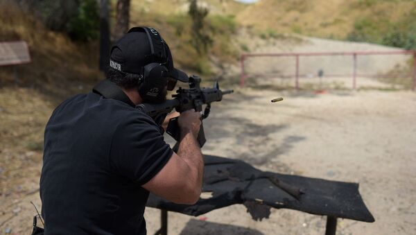 Раввин Разиэль Коэн, он же тактический раввин, стреляет из полуавтоматической винтовки AR-15 во время демонстрации на стрельбищах Анджелеса (20 мая 2019). Пакоймa - Sputnik Армения