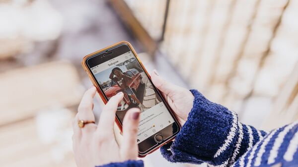 Девушка держит в руках смартфон с открытым приложением Instagram - Sputnik Армения