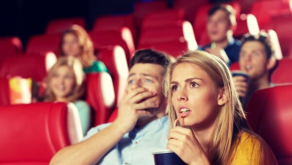 Девушка-блондинка с друзьями смотрит фильм ужасов в кинотеатре - Sputnik Армения