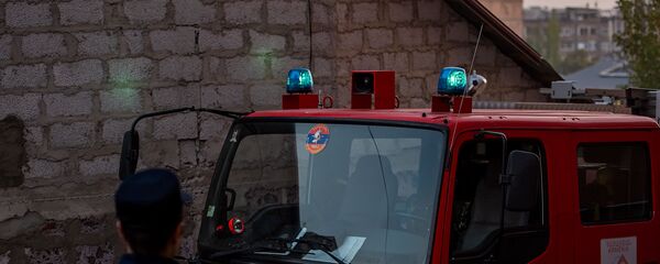 Сотрудник МЧС Армении у пожарного автомобиля - Sputnik Արմենիա