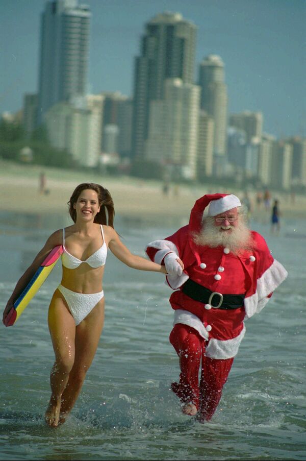 Австралийка и Санта-Клаус на пляже в Квинсленде, Австралия - Sputnik Армения