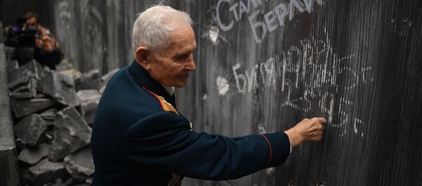 Ветеран Великой Отечественной войны Ростислав Дмитриевич Битянов наносит надпись на стену Рейхстага в историко-художественной панораме Битва за Берлин - Sputnik Армения