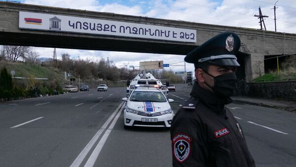 Сотрудник военной полиции проверяет документы у водителей и пассажиров автомобилей, выезжающего из столицы (2 апреля 2020). Еревaн - Sputnik Армения