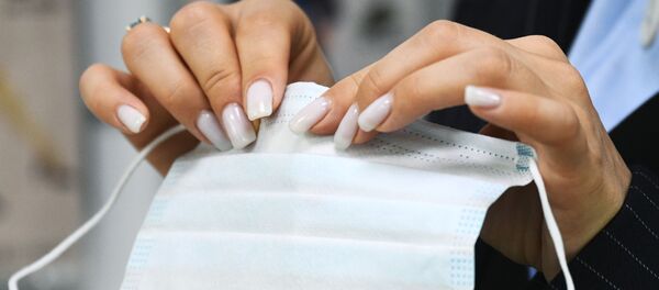 Девушка держит медицинскую маску  - Sputnik Արմենիա