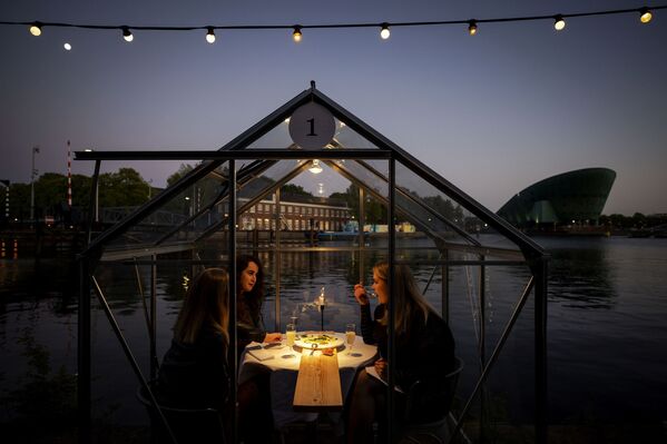 Друзья во время обеда в ресторане в формате «карантинных теплиц» в Амстердаме  - Sputnik Армения