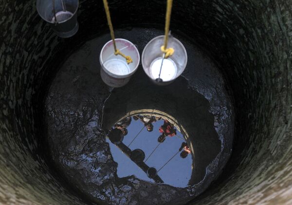 Индийские жители деревни Падал в округе Самба пытаются зачерпнуть воду в ведра - Sputnik Армения