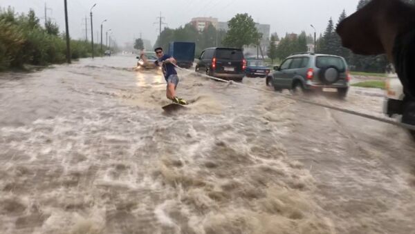 СПУТНИК_В Пскове парень проехался по затопленной после дождя улице на вейкборде - Sputnik Армения