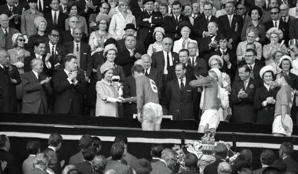 Королева Англии Елизавета II вручает приз VIII первенства мира по футболу Кубок Золотая богиня капитану английской сборной Роберту (Бобби) Муру - Sputnik Армения